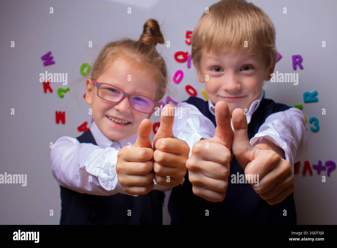 Happy pupils showing thumbs up. Back to school concept Stock Photo - Alamy
