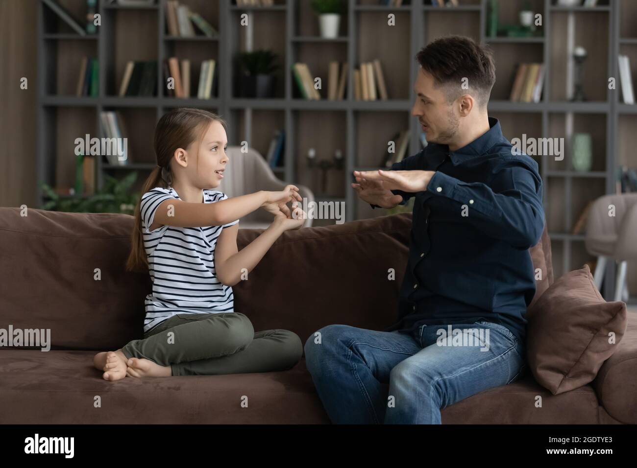 Deaf girl her father speaking without words showing gestures Stock Photo
