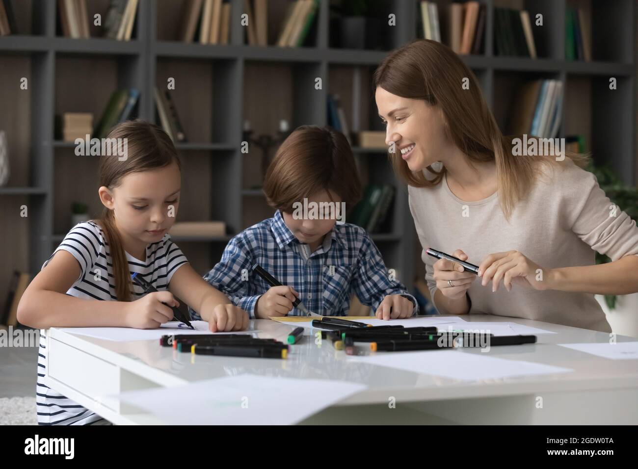 Mother and little kids draw together with color felt pens Stock Photo ...