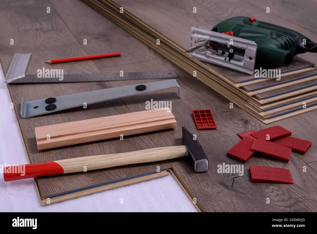 Equipment or tools to install laminate floor, hammer, electric jig saw