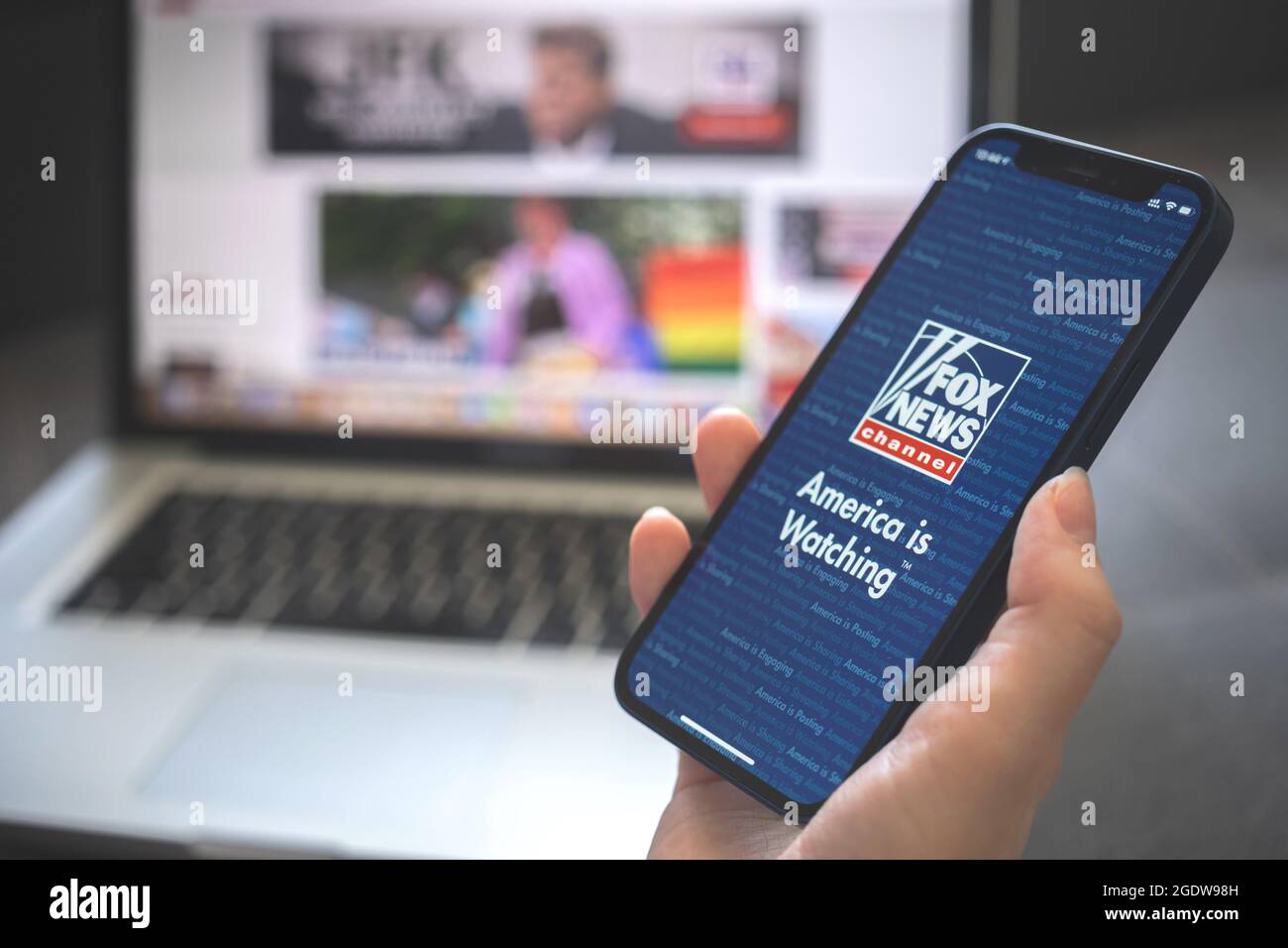 Kharkov, Ukraine - August 12, 2021: Fox News app. Woman using smartphone with fox news application. Brand logo Stock Photo