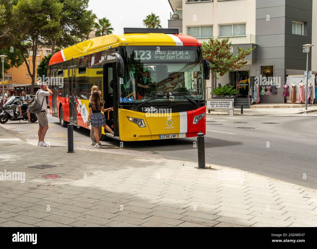 Palmanova, Spain; august 10 2021: Bus stop of the TIB company in the Majorcan tourist resort of Palmanova. Users and driver wearing face mask because Stock Photo