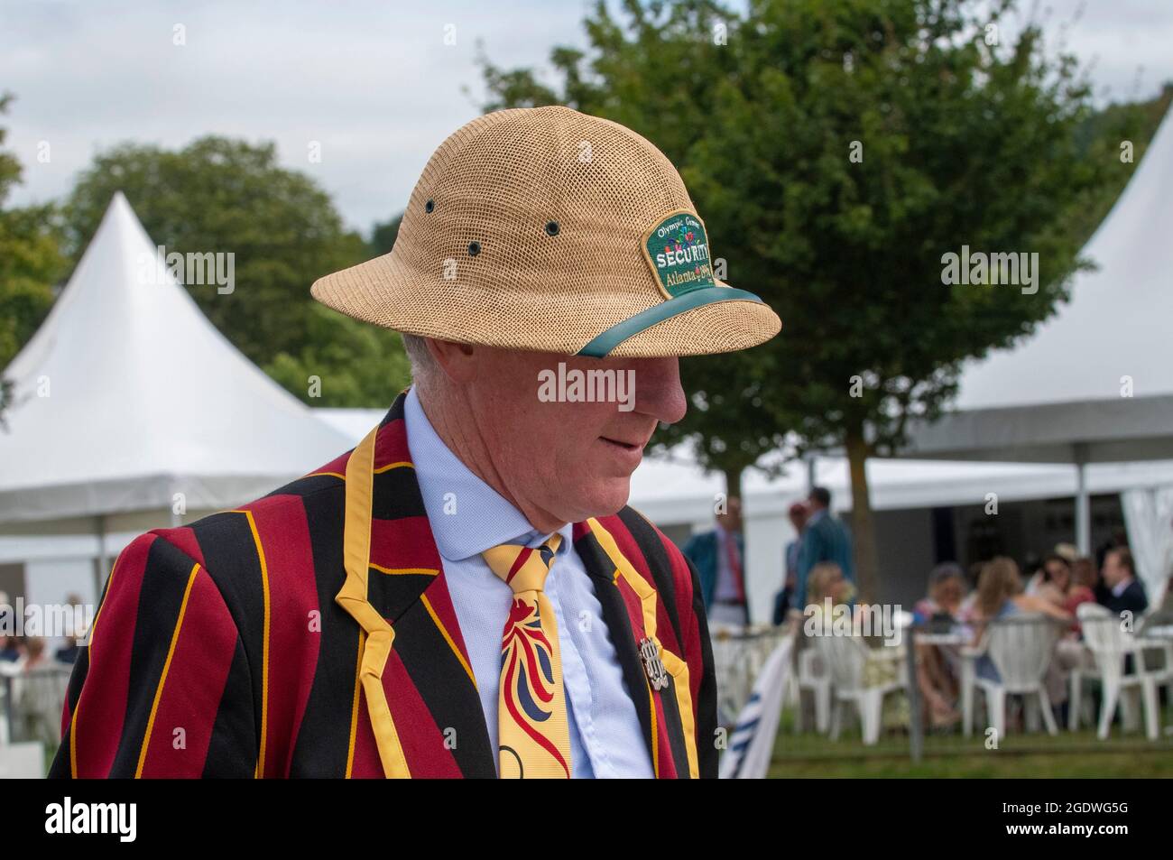 Henley Royal Regatta, 14 August 2021 HRR Umpire wearing a straw pith helmet( from a previous event -Olympic Games Atlanta 1996- Security) disembarking from the Umpires Launch as it docks after the race Credit: Gary Blake/Alamy Live News Stock Photo