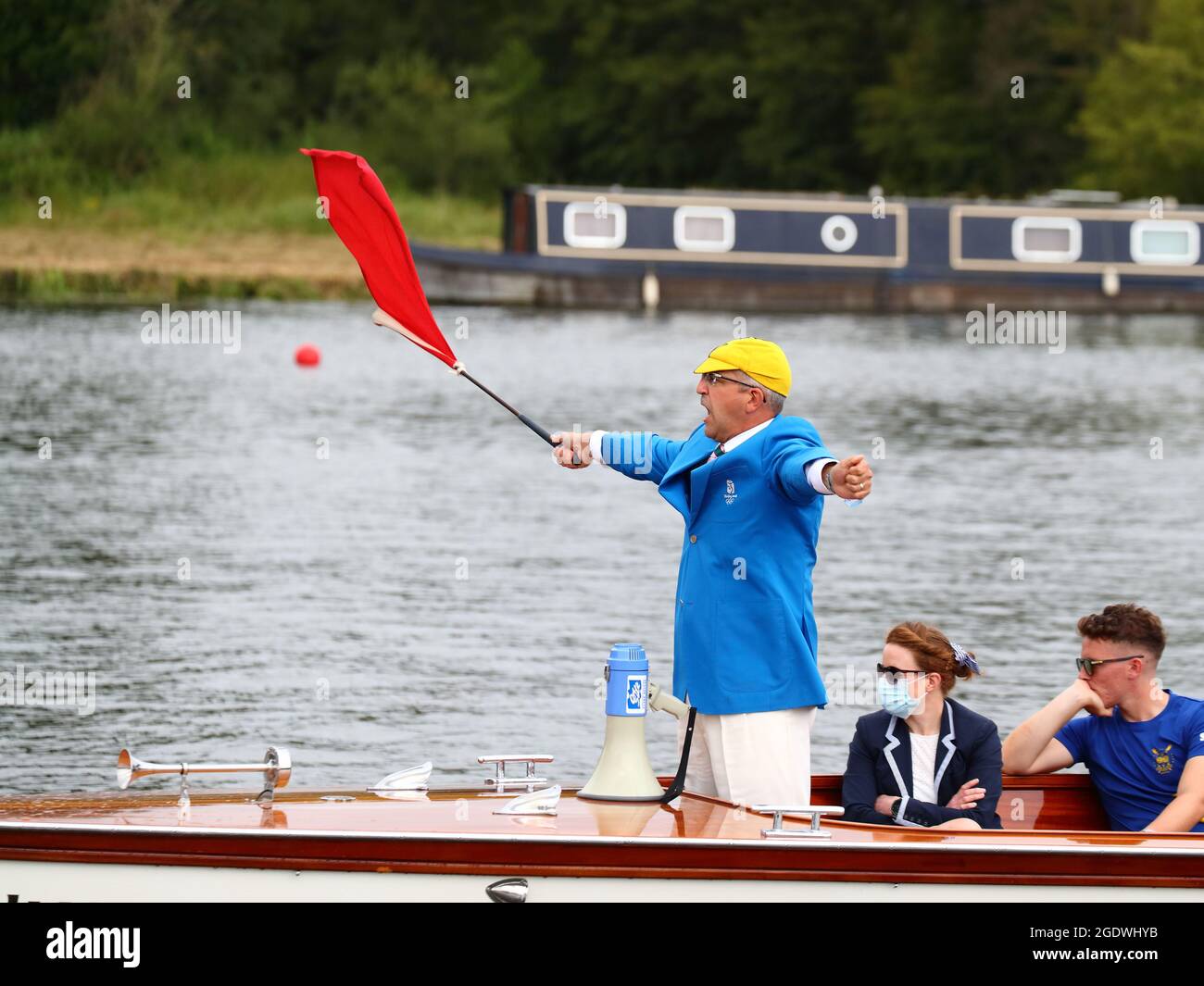 The Umpire starts a race waving a red flag at the Henley Royal Regatta