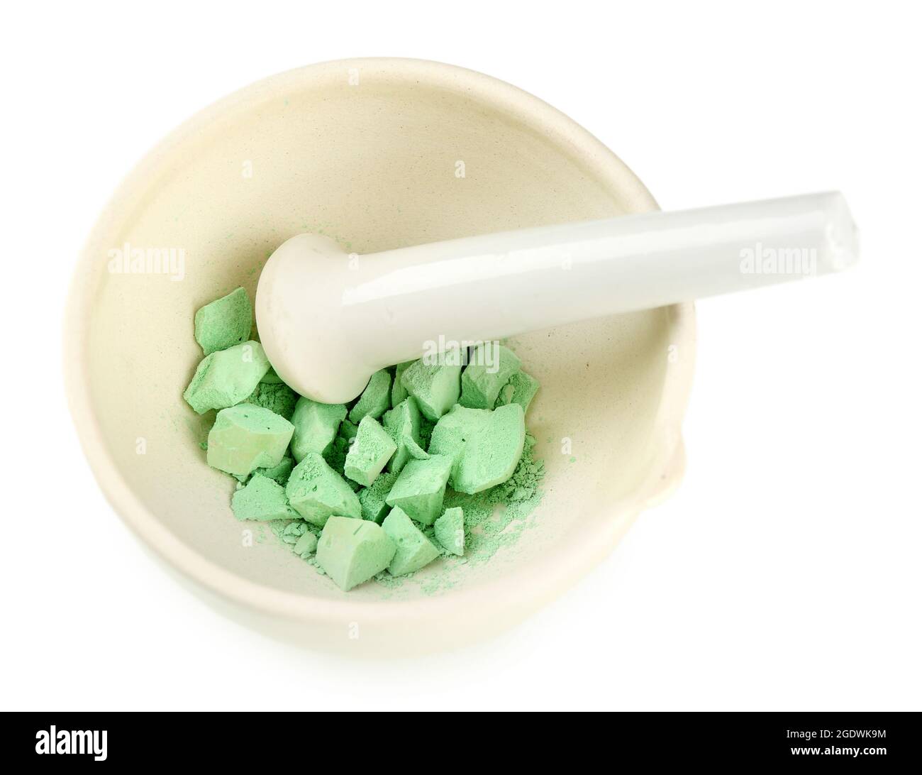 Laboratory pestle in mortar with ground material, isolated on white