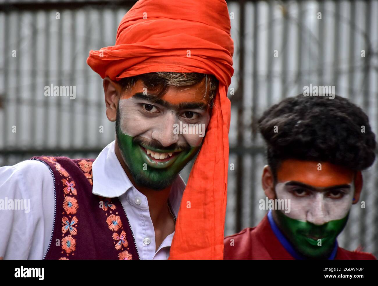 Artists with their faces painted in colors of the Indian flag attend ...