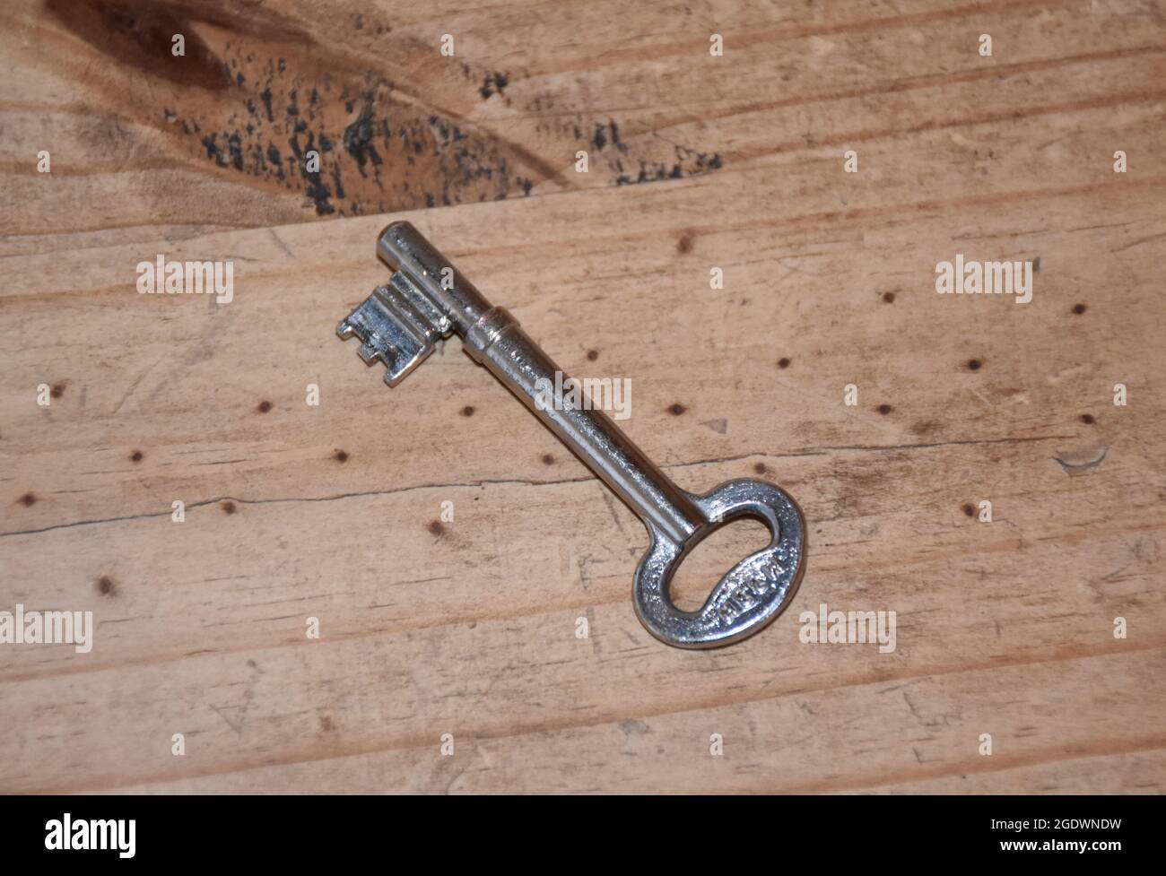Medieval skeleton key on a wooden table Stock Photo - Alamy