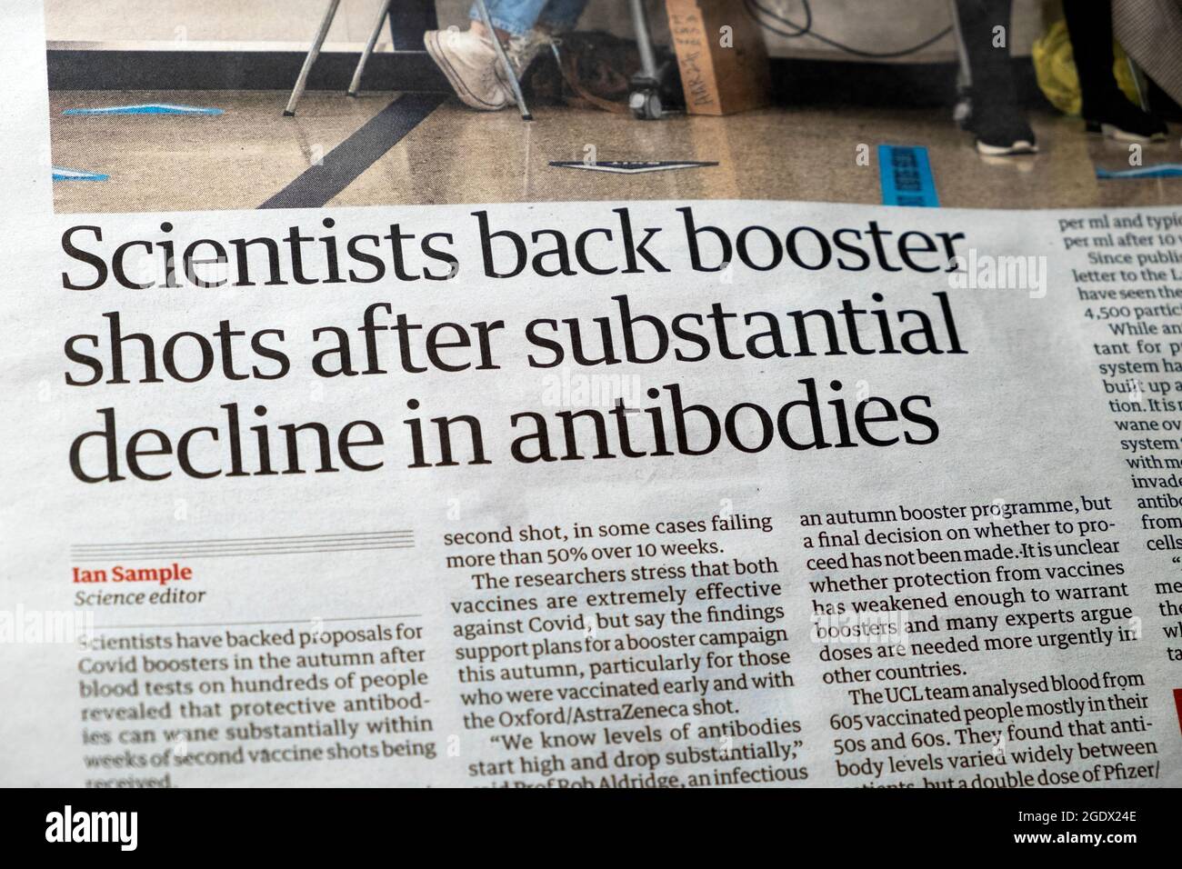 'Scientists back booster shots after substantial decline in antibodies' Guardian newspaper headline article inside page on 16 July 2021 in  London UK Stock Photo