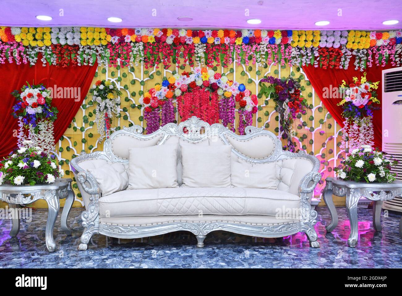 Banquet Hall Stage Decorated with flowers. Marriage Bride and Groom