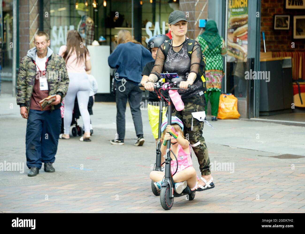 Family on electric scooters, in the City Stock Photo