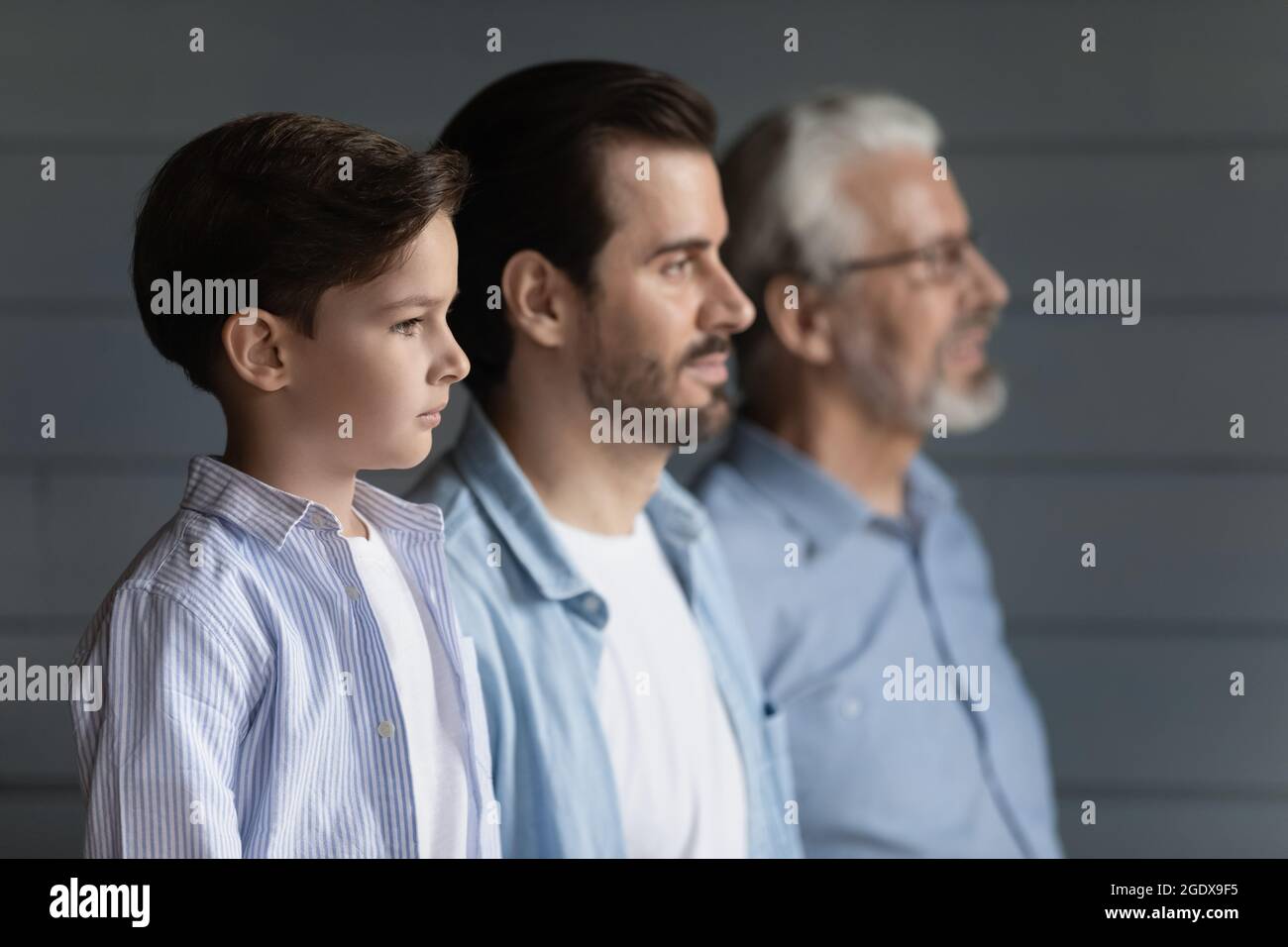 Three generations of men pose together showing unity Stock Photo