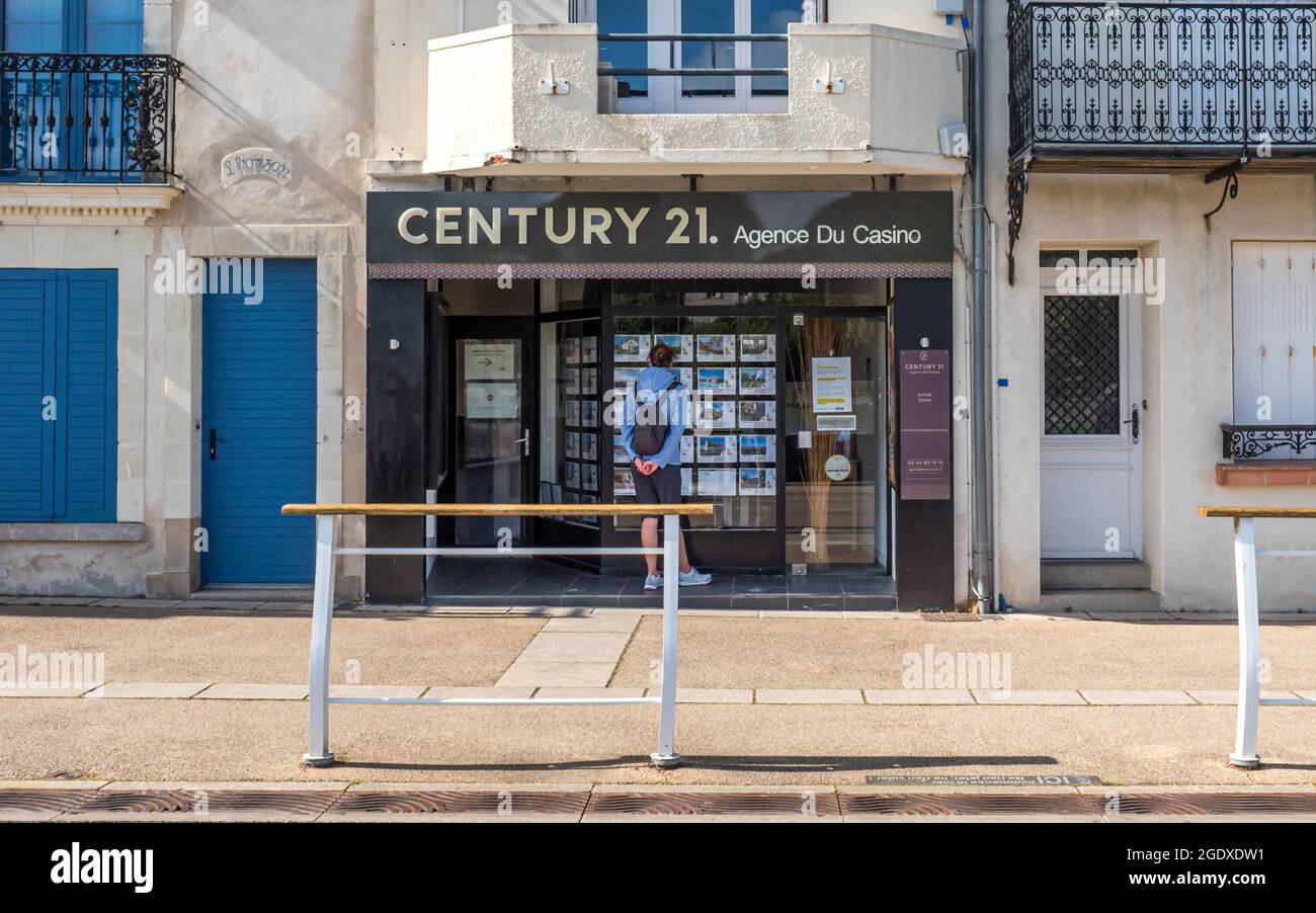 PORNIC, FRANCE - Jul 31, 2021: A man stanidng in front of the CENTURY 21 store in Pornic, France Stock Photo