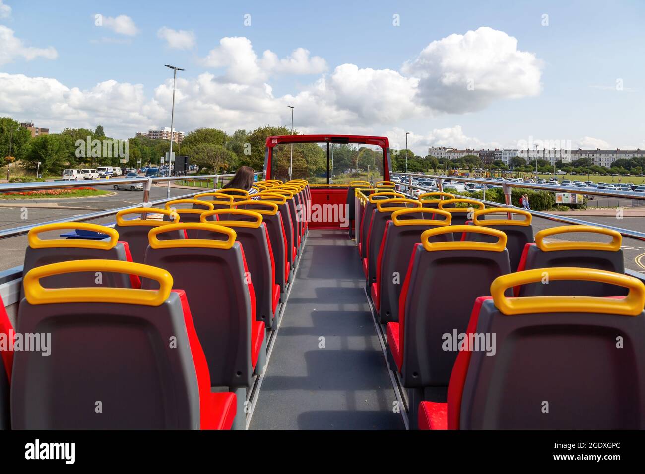 Inside the top deck of an open top bus with passenger Stock Photo