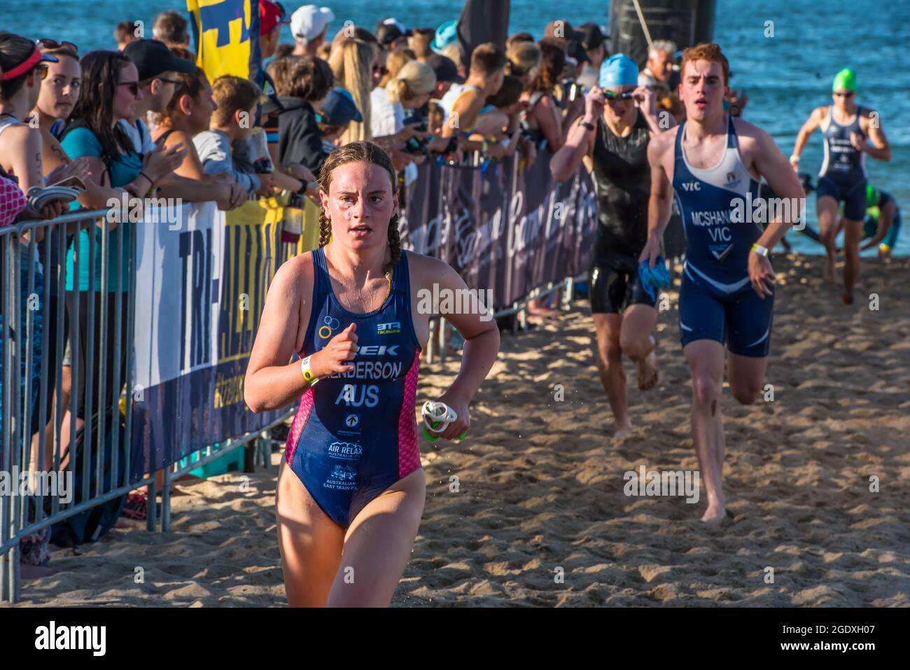Melbourne, Australia. 03rd Feb, 2019. Triathletes are seen running on the sand after swimming race
