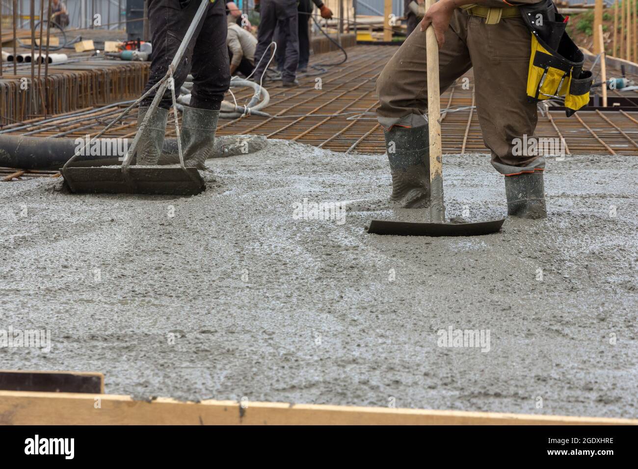 The Process Of Pouring A Monolithic Slab At A Construction Site Construction Workers Leveling Wet Concrete Has Been Poured Concreting Works At A Con Stock Photo Alamy