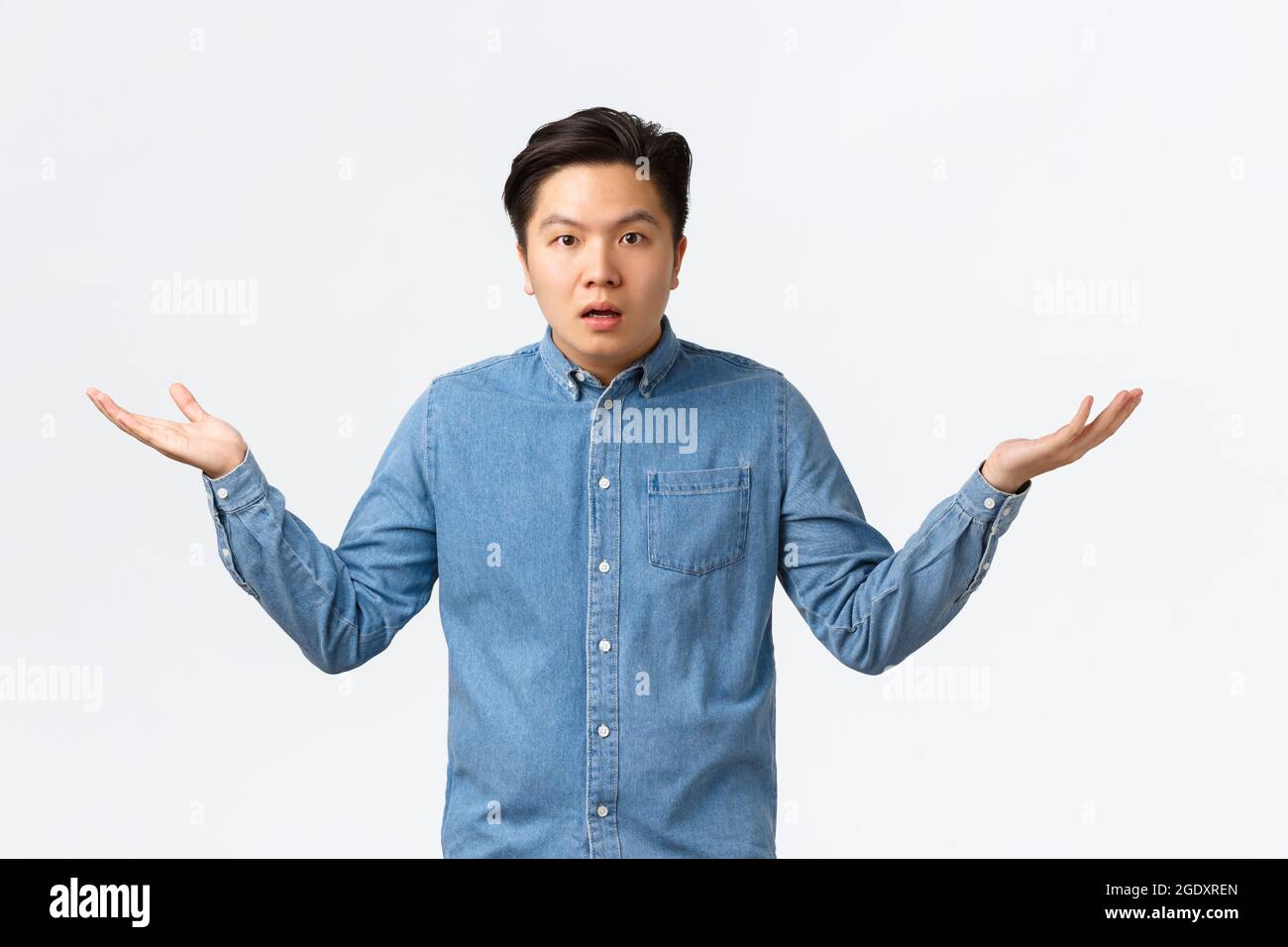Confused and puzzled asian man in shirt cant understand what happening ...