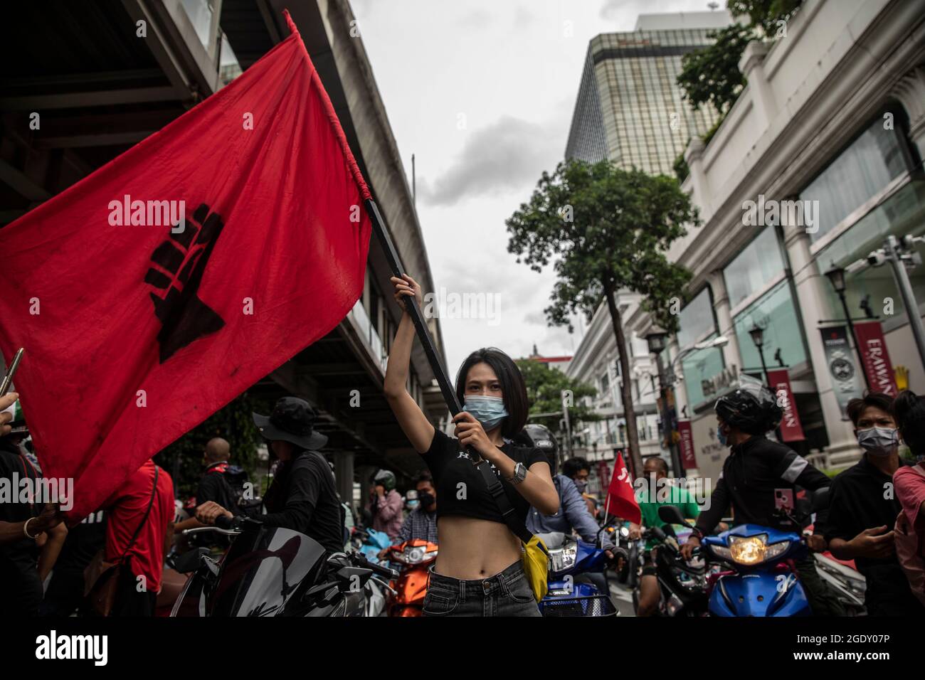 Thailand. 15th Aug, 2021. Red Shirt supporters gather at Ratchaphrasong intersection before a motorbike rally in Bangkok, Thailand on August 15, 2021. A city-wide motorbike rally, made up primarily of Red Shirts and headed by former lawmaker, Nattawut Saikuar, rode through Bangkok peacefully, urging protestors not to become violent. However, some protestors, mostly youth groups like REDEM, tried once again to reach the residence of Thai Prime Minister, Prayuth Chan-Ocha, that inevitably ended in clashes with law enforcement. (Credit Image: © Andre Malerba/ZUMA Press Wire) Stock Photo
