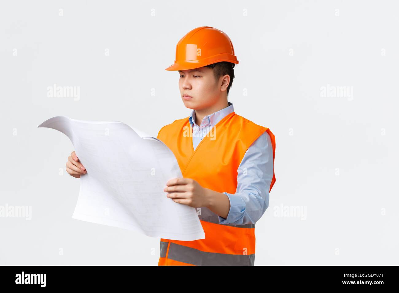 Building sector and industrial workers concept. Serious-looking asian ...