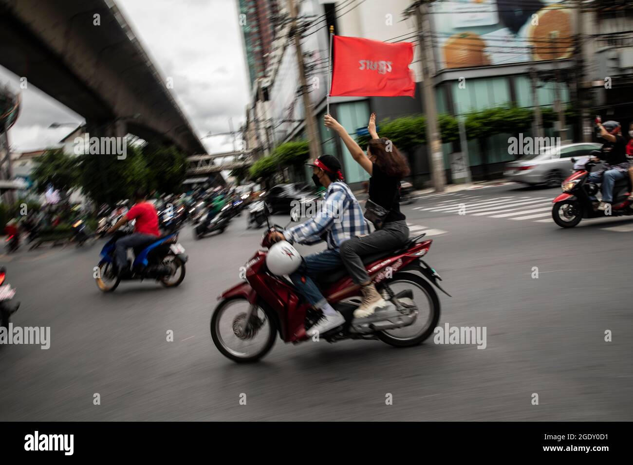 Thailand. 15th Aug, 2021. Red Shirt supporters participate in a motorbike rally in Bangkok, Thailand on August 15, 2021. A city-wide motorbike rally, made up primarily of Red Shirts and headed by former lawmaker, Nattawut Saikuar, rode through Bangkok peacefully, urging protestors not to become violent. However, some protestors, mostly youth groups like REDEM, tried once again to reach the residence of Thai Prime Minister, Prayuth Chan-Ocha, that inevitably ended in clashes with law enforcement. (Credit Image: © Andre Malerba/ZUMA Press Wire) Stock Photo