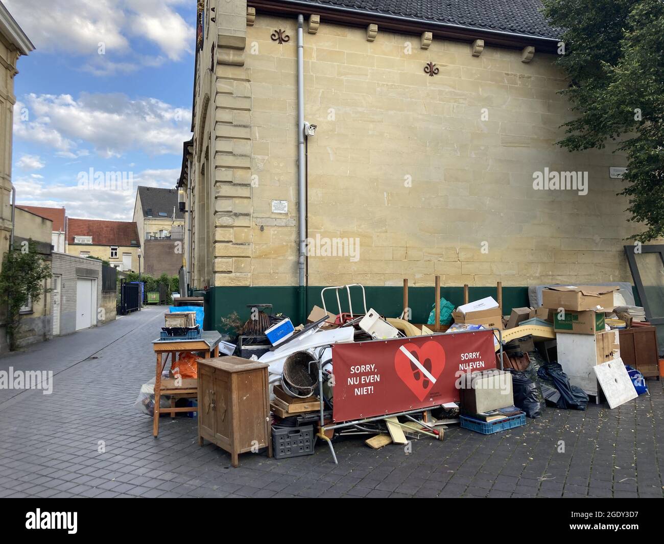 VALKENBURG, NETHERLANDS - Aug 07, 2021: The damaged belongings and household items stacked on the street after the  flood in Valkenburg Stock Photo