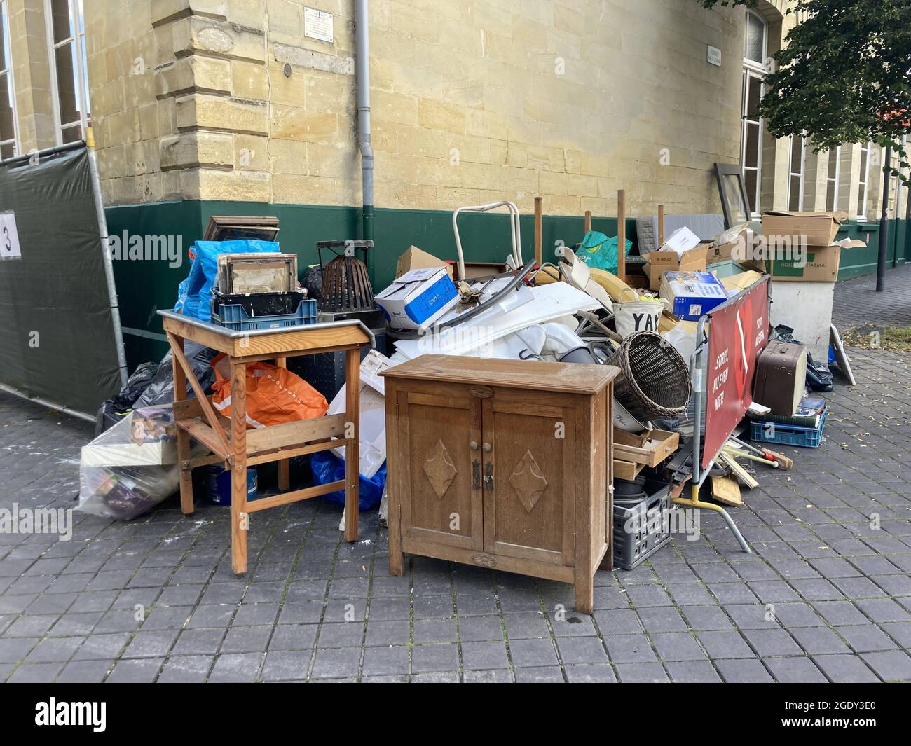 VALKENBURG, NETHERLANDS - Aug 07, 2021: The damaged belongings and household items stacked on the street after the  flood in Valkenburg Stock Photo