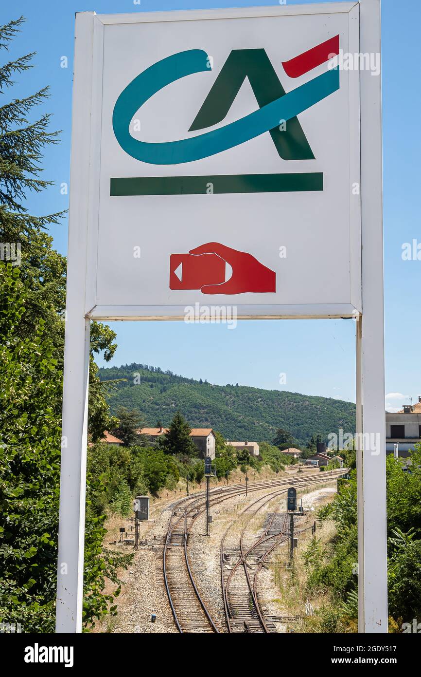Sisteron, France - July 7, 2020: A sign of a Bank Credit Agricole above railway in Sisteron Stock Photo