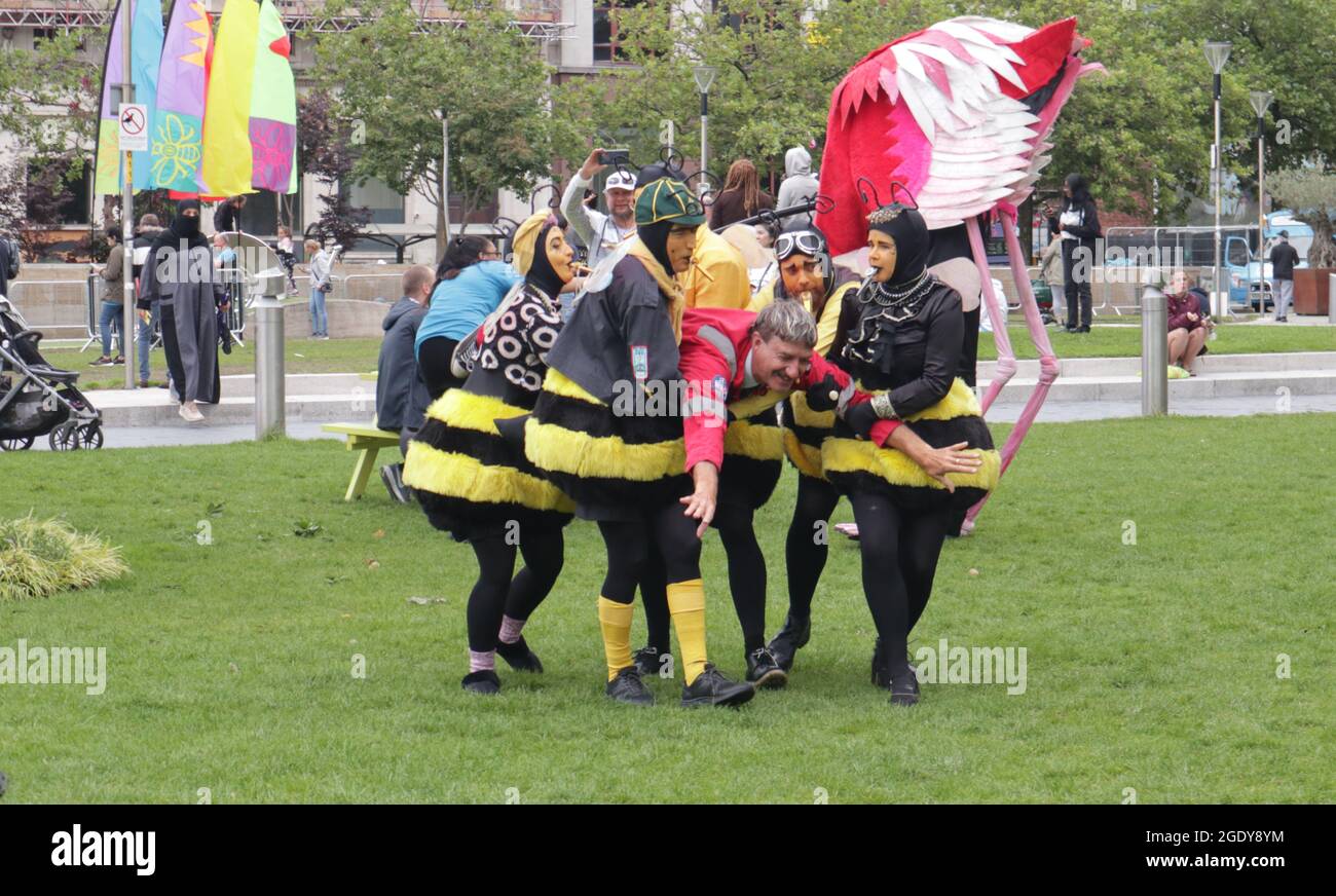 Manchester England 15 August 2021.  Performers entertaining crowds in Piccadilly Garden as part of the “Thank You Manchester” event put on by Manchester Council.  Performers included bright pink Flamingos named Issiah and Florence, and charming beekeeper double act The Bee Cart (pictured). Stock Photo