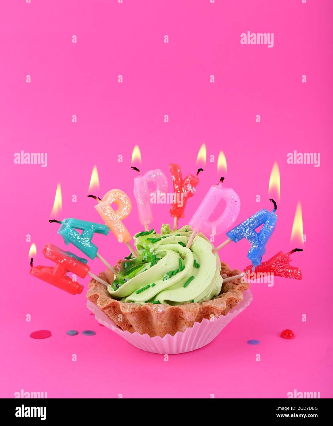 Cake with birthday candles on pink background Stock Photo - Alamy