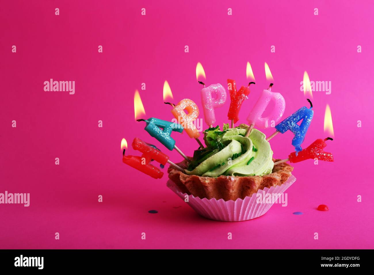 Cake with birthday candles on pink background Stock Photo - Alamy
