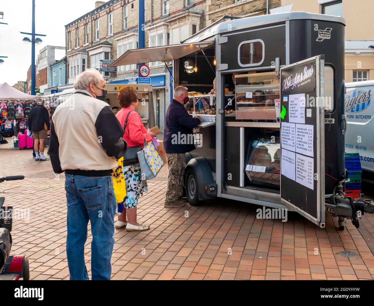A socially distanced queue waiting to buy from  H Taylor and Sons meat and pie stall in the weekly market in Redcar Stock Photo