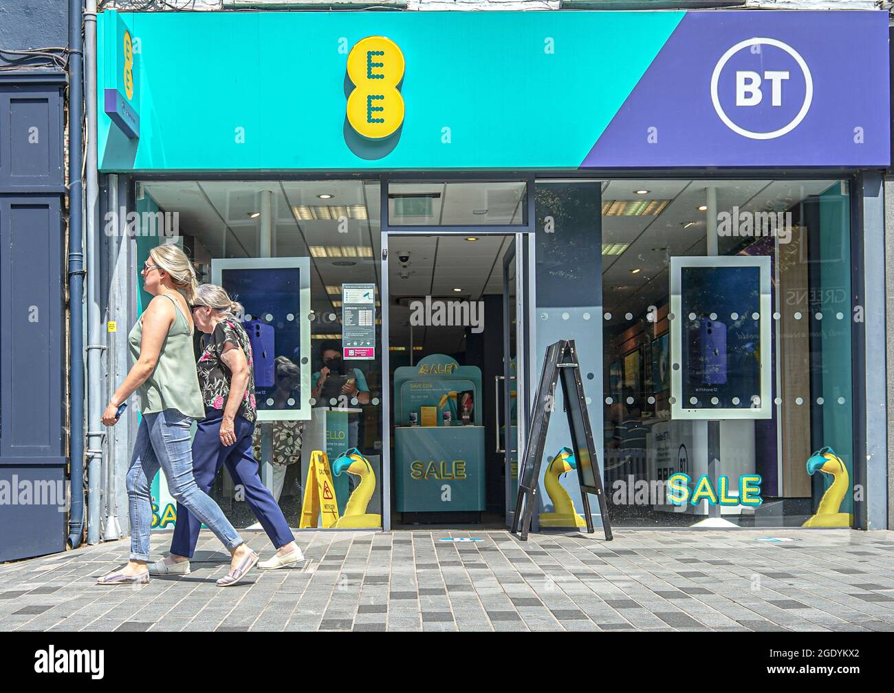 Shoppers walk past ee bt mobile communications store on bow street in