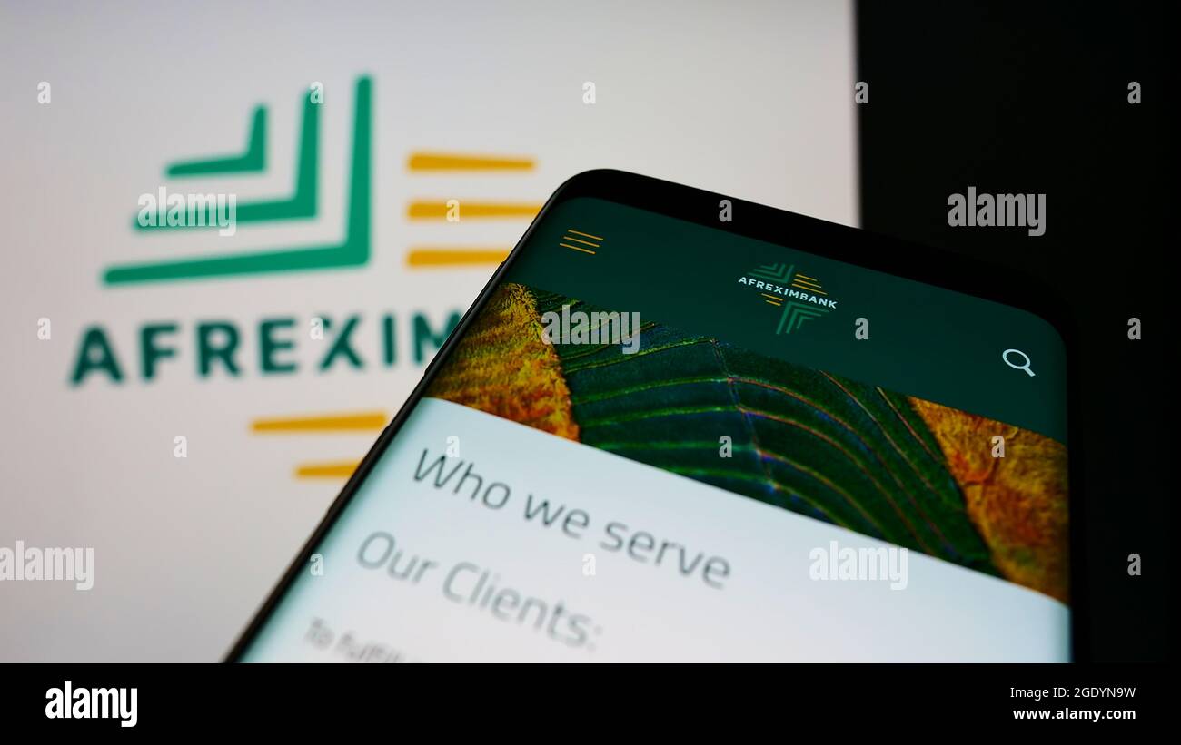 Cellpohone with webpage of company African Export–Import Bank (Afreximbank) on screen in front of business logo. Focus on top-left of phone display. Stock Photo