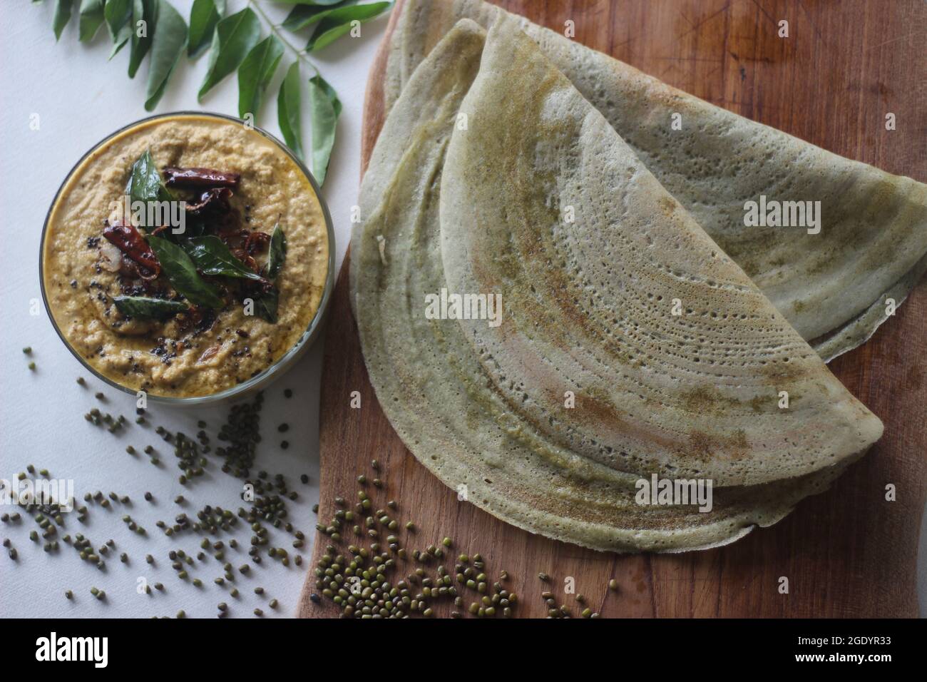 Protein rich moong bean crepe, locally known as pesarattu. It looks like dosa but not made with fermented batter. Served folded along with coconut chu Stock Photo