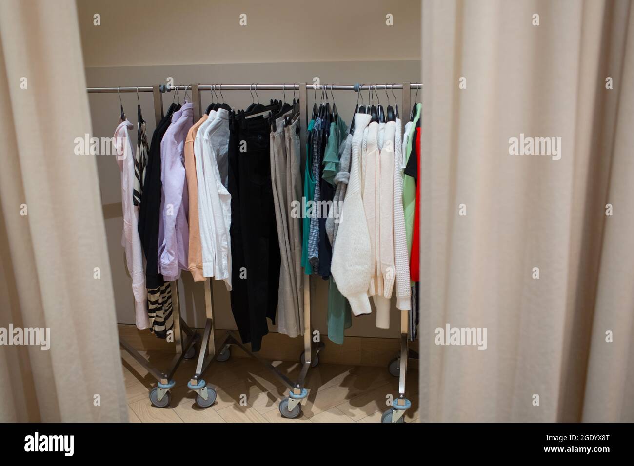 Different clothes on hangers in dressing room Stock Photo Alamy