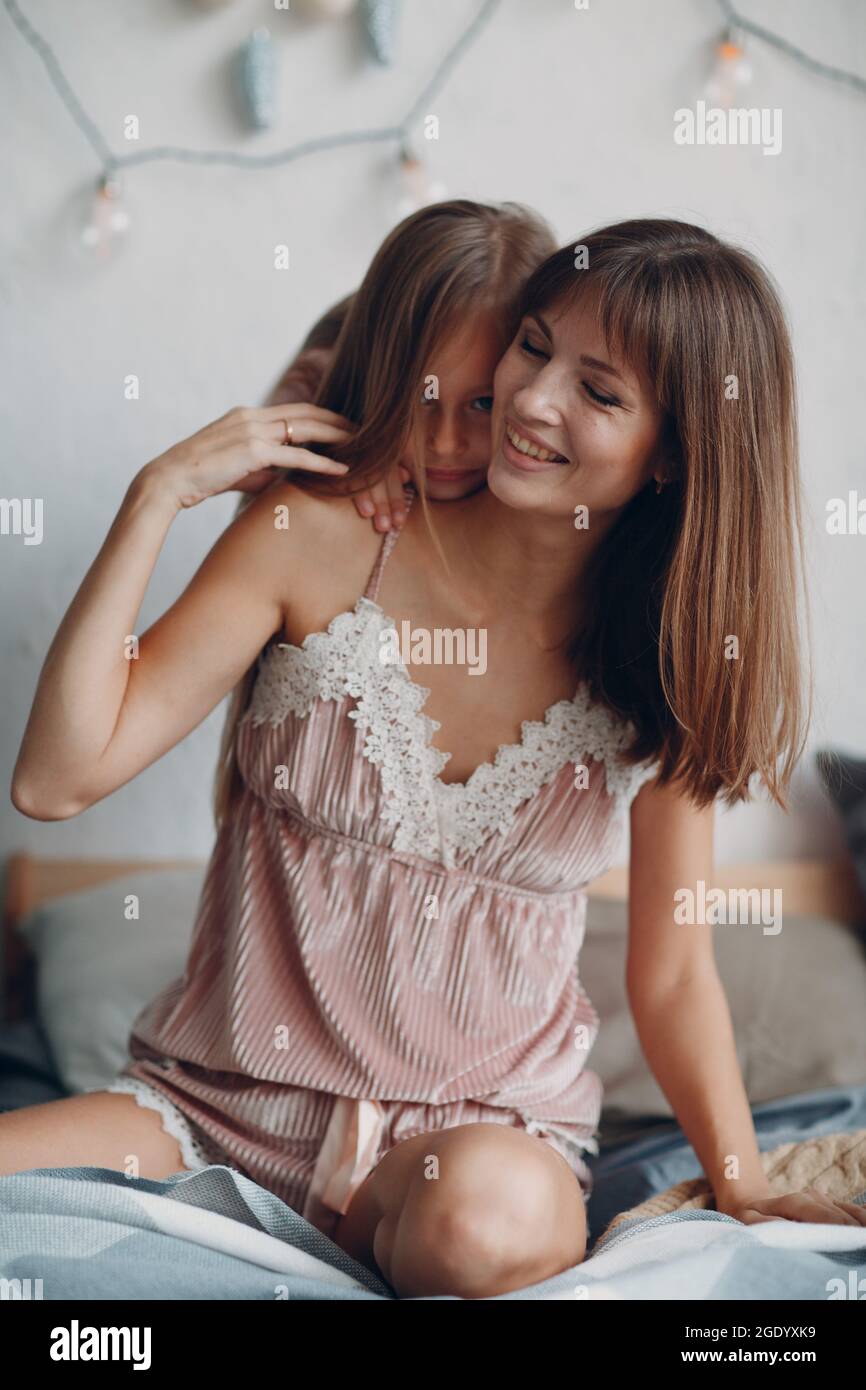 Mother and little daughter child girl at home. Single parenting and motherhood. Stock Photo