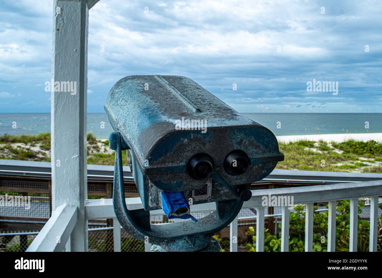 Binocular view from Port Boca Grande Lighthouse and Museum stand strong on Gasparilla Island as a tropical storm with black clouds loom off the coast Stock Photo