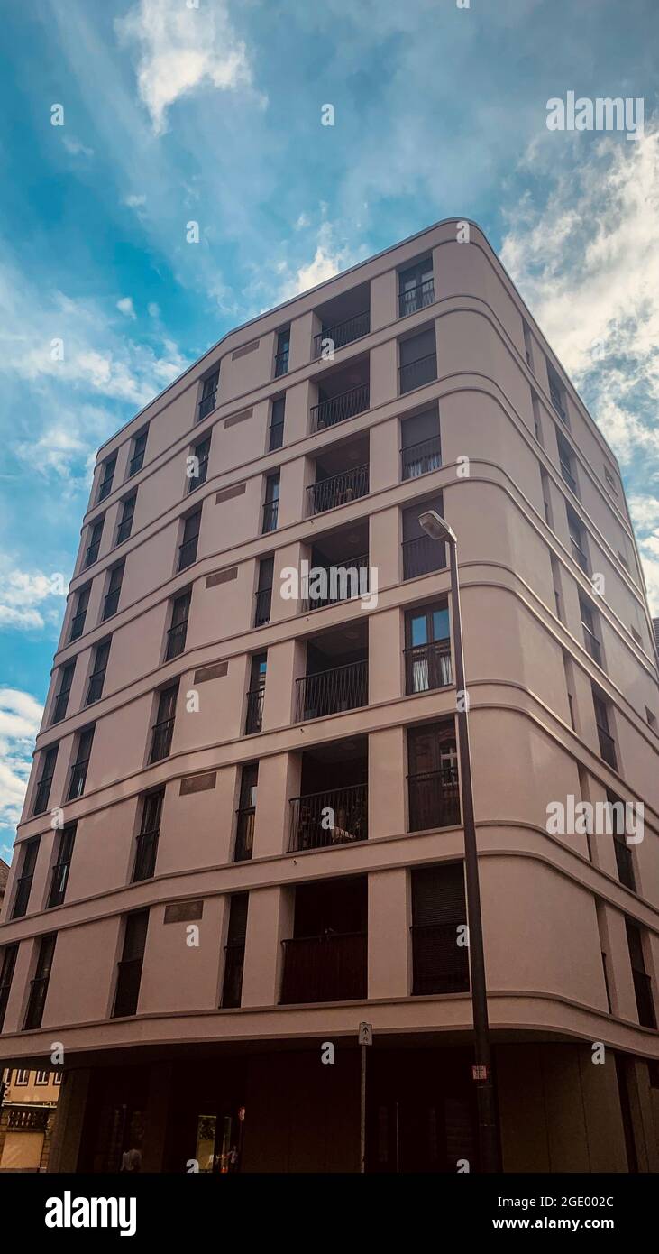A low angle vertical shot of a high rise building under the blue sky ...