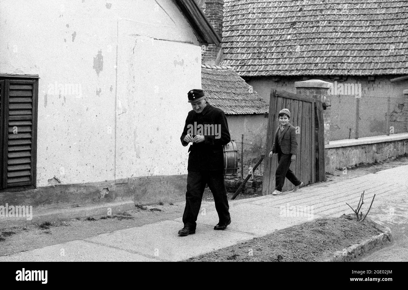 Hungarian man in uniform and child walking in village near Budapest, Hungary 1956 Stock Photo