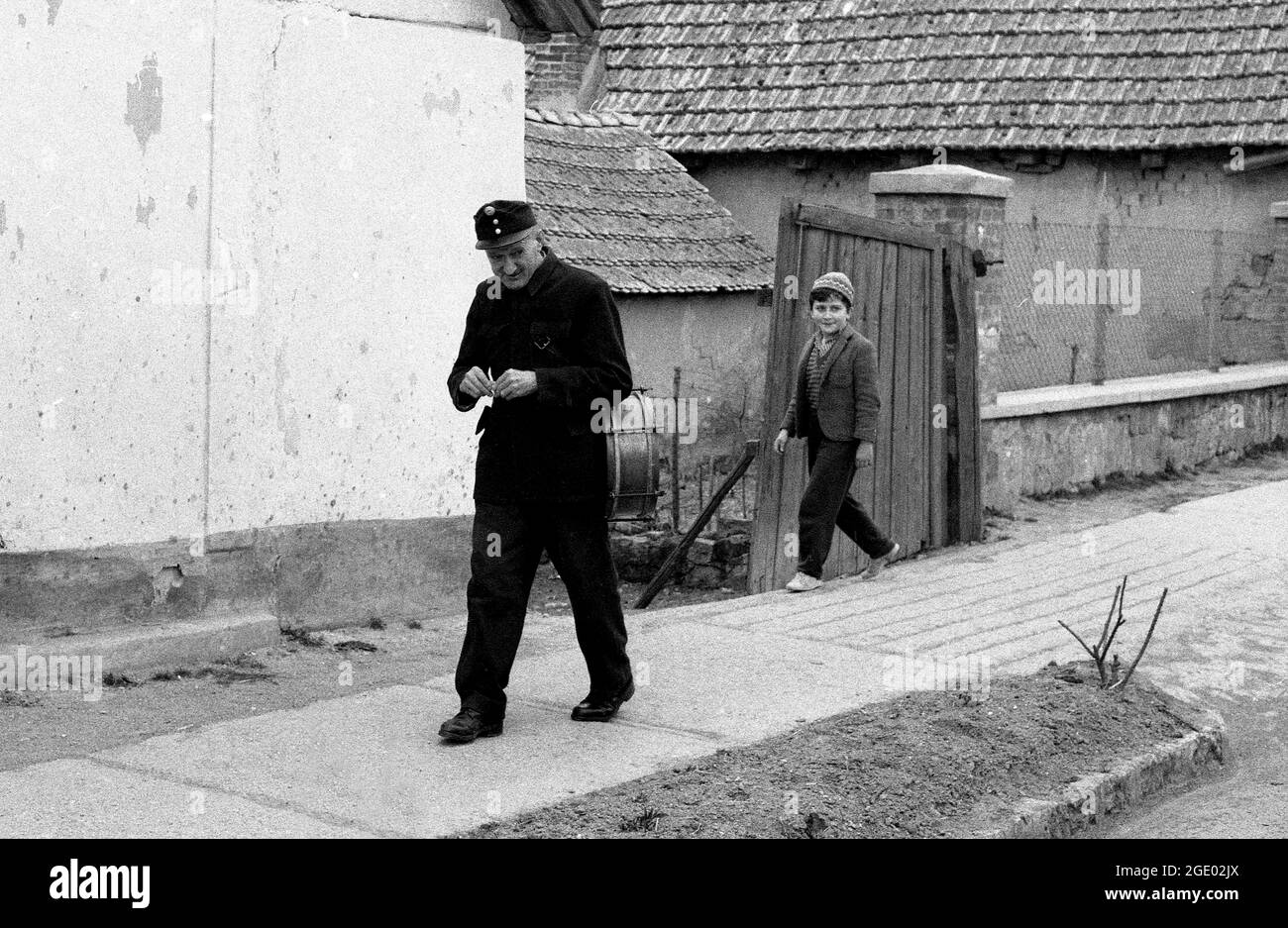 Hungarian man in uniform and child walking in village near Budapest, Hungary 1956 Stock Photo