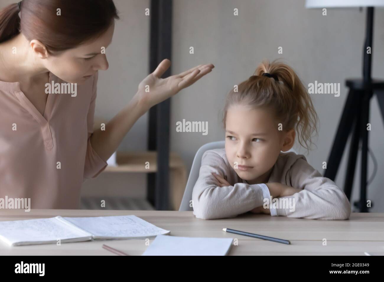 Unhappy mom scold lazy unmotivated daughter studying Stock Photo