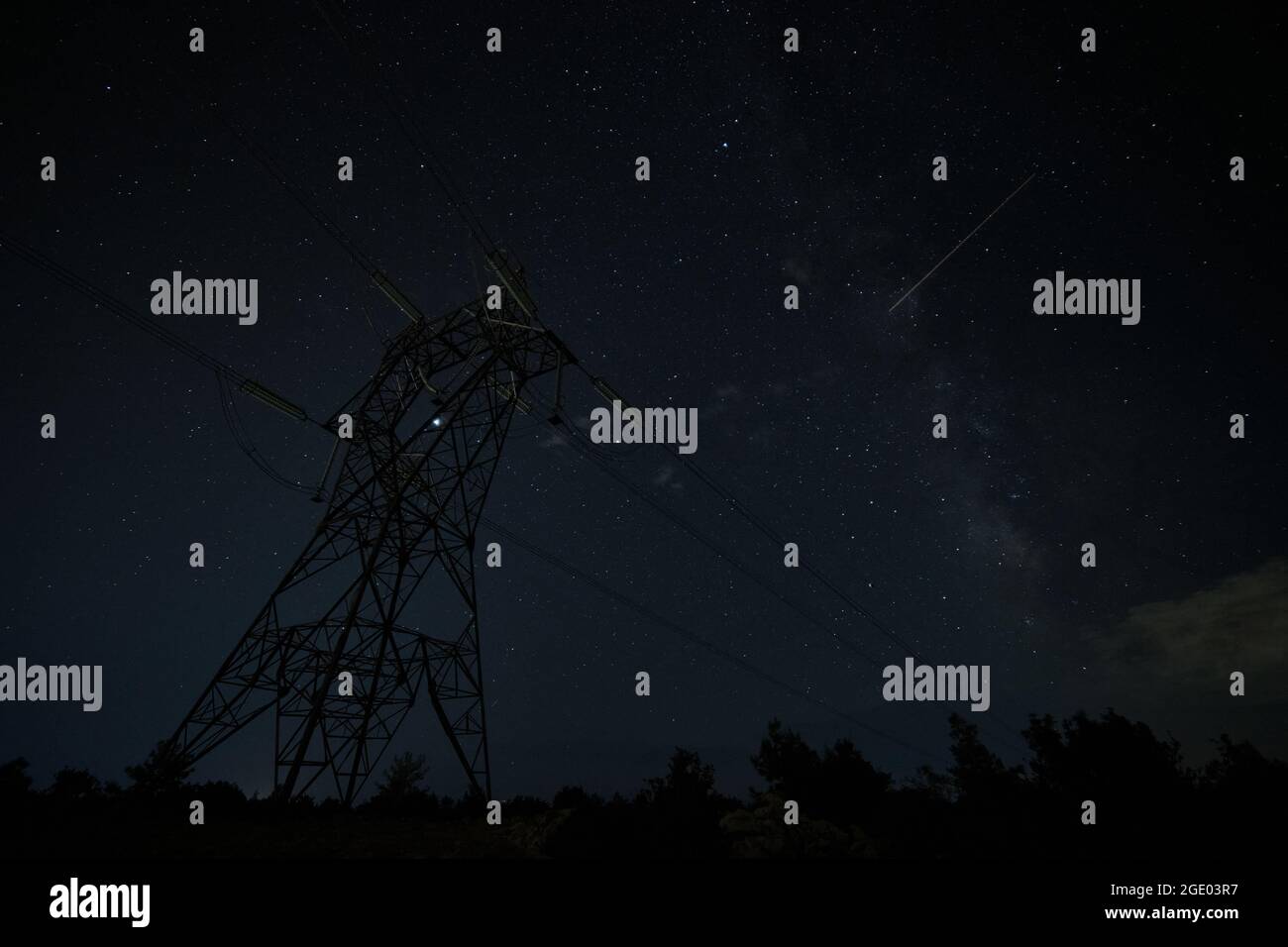 Power line pylon against summer starry night Stock Photo