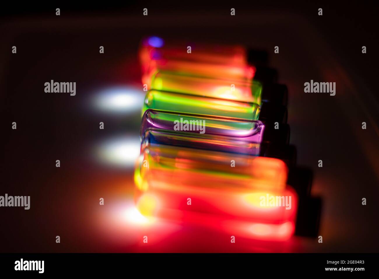 Various colourful reagents in glass vials on UV light in a chemistry