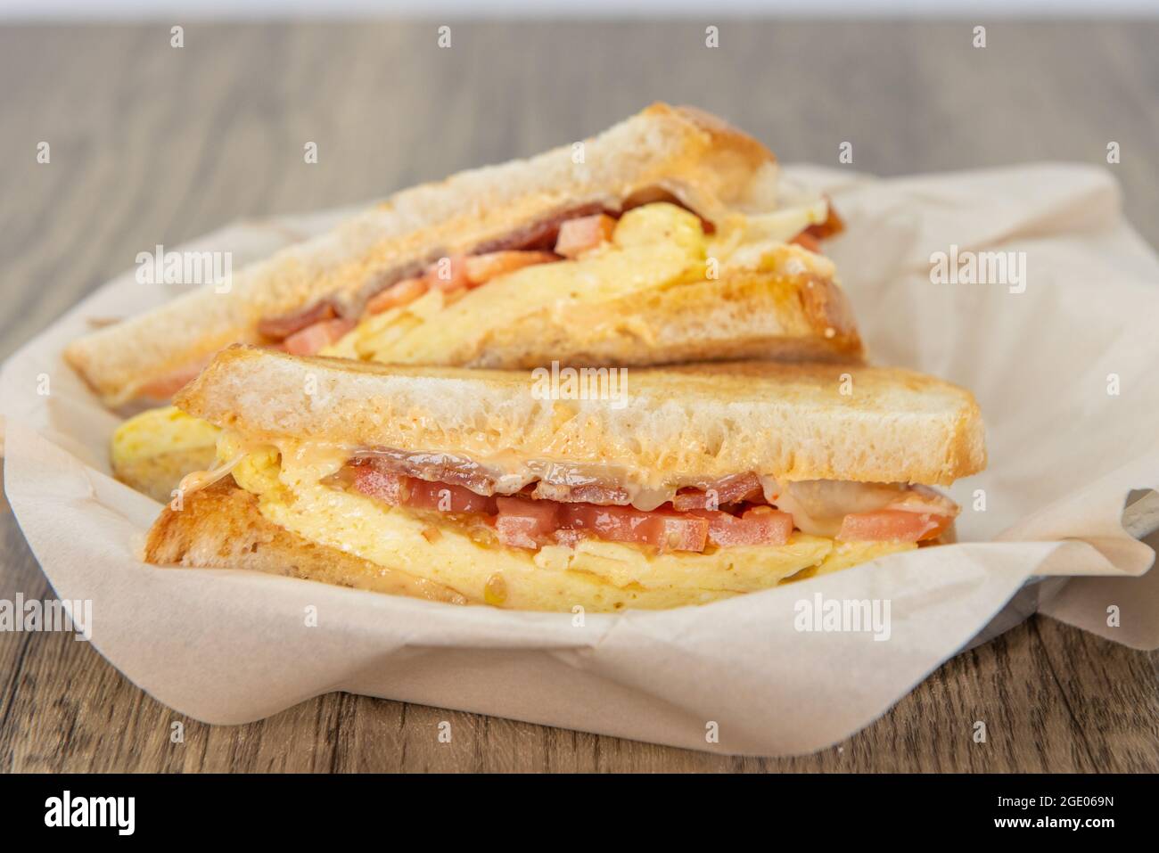Breakfast ham and cheese sandwich loaded with all the good fixings to completely fill any appetite for a meal. Stock Photo