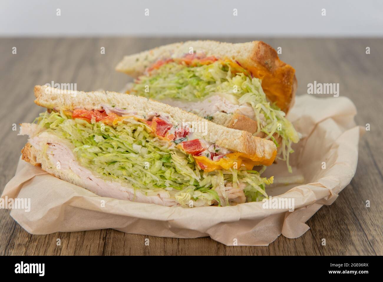 Turkey, mayo, and lettuce sandwich loaded with all the good fixings to completely fill any appetite for a meal. Stock Photo