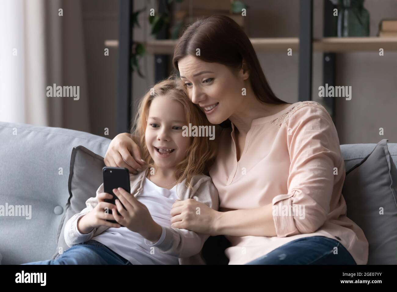 Happy young mom and small daughter talk on video call Stock Photo - Alamy