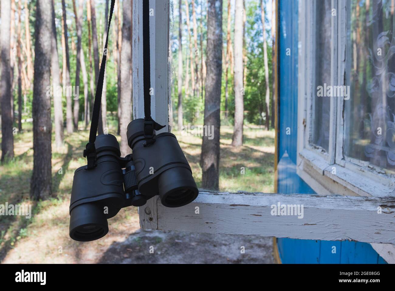 Binoculars in the forest on the window, travel Stock Photo Alamy