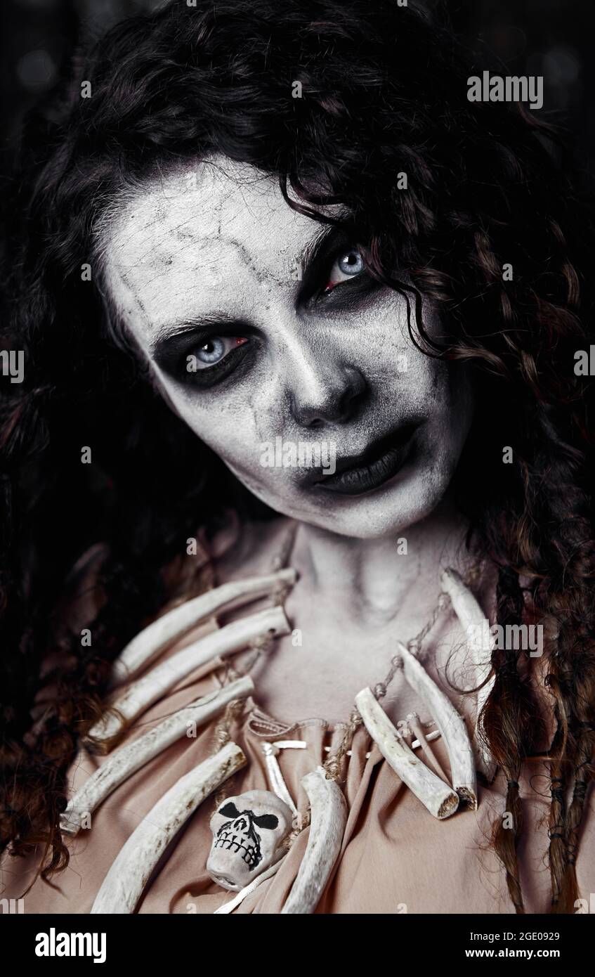 Halloween theme: creepy ugly voodoo witch. Close-up portrait of the evil sorceress. Zombie woman (undead) Stock Photo
