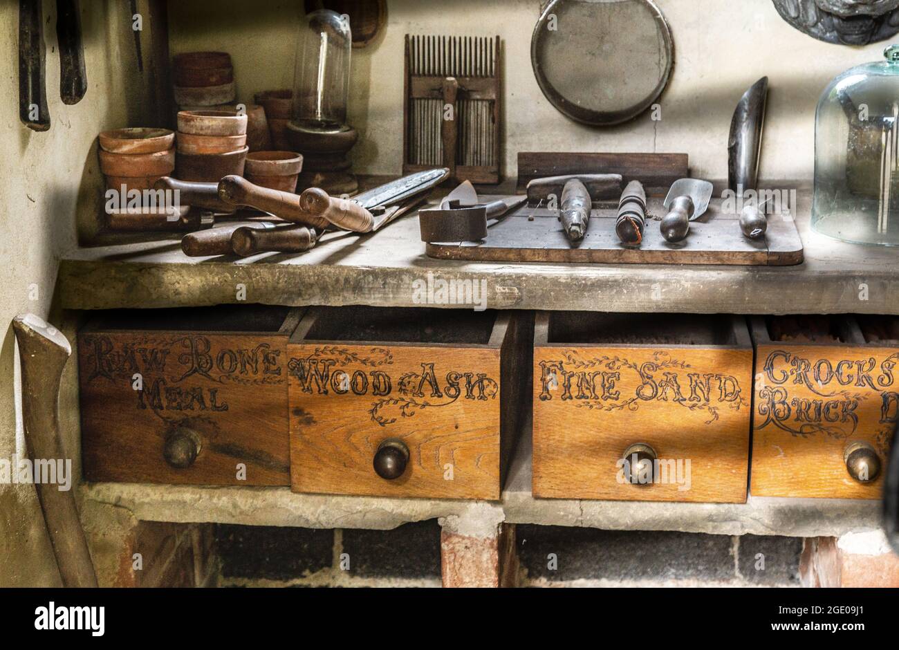 A work bench of old garden tools in a potting shed at York Gate Garden
