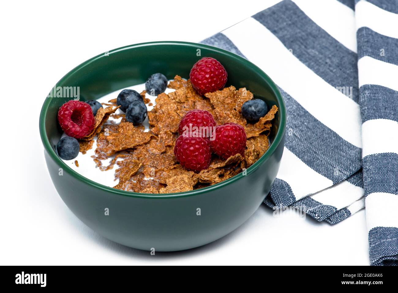 Muesli, isolate on white. Breakfast, healthy food and diet. Muesli with fruits and milk in a plate. Blueberries, strawberries and raspberries on a Stock Photo
