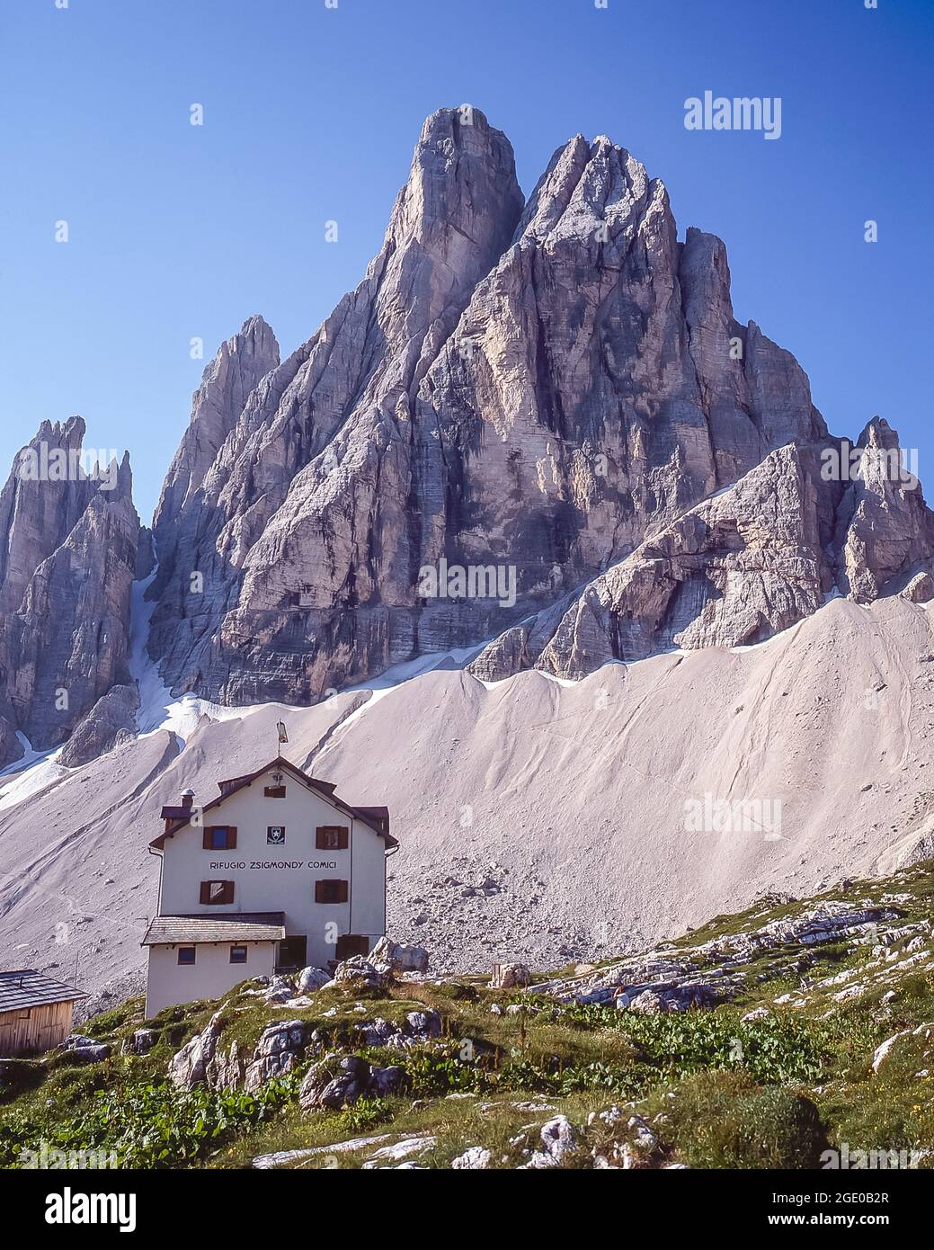 This is the Italian Alpine Club CAI owned Rifugio Comici-Zsigmondy mountain refuge with the formidable peak of the Zwolferkogel in the Sexton-Sesto Dolomites region of the Italian Dolomites, the Alto Adige of the Sud Tyrol not far from the resort town of Cortina d'Ampezzo Stock Photo